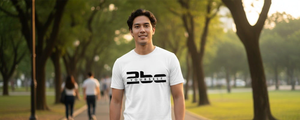 Man wearing a white t-shirt with a logo in a park